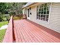 View of the spacious wood deck with a railing, and the front entrance at 6348 Kingsley Dr, Indianapolis, IN 46220