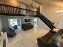 Bright open living space with lofted area and staircase access, perfect for entertaining at 11720 Grenadier Ln, Indianapolis, IN 46229