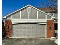 Attached garage with brick facade and gray door at 3422 Admiralty Ln, Indianapolis, IN 46240