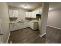 Newly remodeled kitchen with white cabinets and grey flooring at 3940 N Webster Ave, Indianapolis, IN 46226