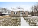 Brick bungalow with a snow-covered front yard at 11623 Deanna Dr, Indianapolis, IN 46229