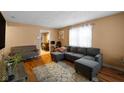 Spacious living room with gray sectional sofa and wood floors at 11623 Deanna Dr, Indianapolis, IN 46229