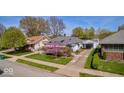Aerial view of a charming home with detached garage, mature trees, and adjacent houses at 1641 Winton Ave, Indianapolis, IN 46224