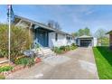 Attractive home with a blue front door, well-kept yard, and detached garage at 1641 Winton Ave, Indianapolis, IN 46224