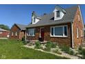 Well-maintained brick house with a bright red front door and a neatly landscaped front yard at 3192 E Main St, Plainfield, IN 46168