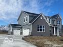 Stunning exterior features a 3-car garage, stone and siding accents for enhanced curb appeal at 6596 Dogwood Dr, McCordsville, IN 46055
