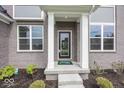 Charming front porch with classic white columns and a stylish front door entrance at 6596 Dogwood Dr, McCordsville, IN 46055