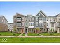 Charming townhomes with colorful doors and well-maintained lawns in a friendly neighborhood setting at 7340 W County Road 600 Rd, McCordsville, IN 46055