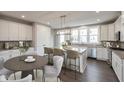 Bright eat-in kitchen features a center island with bar seating, stainless steel appliances and lots of counter space at 7340 W County Road 600 Rd, McCordsville, IN 46055