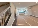 Open concept living space showing stairs, large kitchen with island, and neutral wall colors at 7340 W County Road 600 Rd, McCordsville, IN 46055