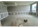 Unfinished living space ready for personalization with wainscoting along the walls and a window at 7344 W County Road 600, McCordsville, IN 46055