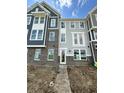 New construction townhome with brick facade, gray siding, and multiple windows at 7348 W County Road 600 Rd # 12-604, McCordsville, IN 46055