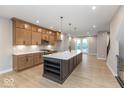 Bright kitchen with a central island, modern pendant lights, and stainless steel appliances at 7348 W County Road 600 Rd # 12-604, McCordsville, IN 46055