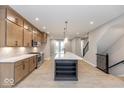 Modern kitchen features a large island, sleek appliances, and ample cabinet space at 7348 W County Road 600 Rd # 12-604, McCordsville, IN 46055