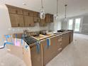 Kitchen with contemporary cabinets and pendant lights, under construction with protected island at 7348 W County Road 600 Rd # 12-604, McCordsville, IN 46055