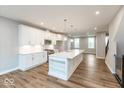 Modern kitchen features an island with quartz countertop and stainless steel appliances at 7352 W County Road 600, McCordsville, IN 46055
