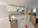 New kitchen with white cabinets and a modern island being installed at 7352 W County Road 600 Rd, McCordsville, IN 46055