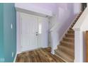 Welcoming entryway features hardwood floors and staircase leading to the upper level at 800 Gondola Run, Greenfield, IN 46140