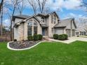 Charming two-story home with well-manicured lawn and a three-car garage at 1242 Bitterwood Ct, Columbus, IN 47201