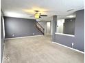 Spacious living area featuring neutral carpet, gray walls, and a ceiling fan for comfortable living at 15314 Clear St, Noblesville, IN 46060