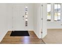 Bright entryway features a modern door with glass, wood-look flooring, and neutral walls at 67 Sterling Pl, New Whiteland, IN 46184