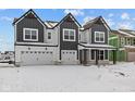 Gorgeous new construction home featuring a three car garage, dark trim, and an inviting front porch at 10603 Banyan Wood Ct, Indianapolis, IN 46239