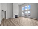 Spacious living room with a fireplace, tall windows, and gorgeous wood floors at 10603 Banyan Wood Ct, Indianapolis, IN 46239