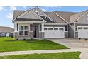 Inviting single-Gathering home showcasing a two-car garage, stone details, and a lush green lawn at 3509 Wrangler Dr, Bargersville, IN 46106
