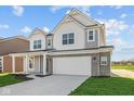 Beautiful home boasts a two-car garage, covered porch, and inviting curb appeal in a bright, cheerful setting at 6114 Paperbark Way, Indianapolis, IN 46259