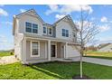 Stunning two-story home with a two-car garage, covered porch, and classic design elements at 6114 Paperbark Way, Indianapolis, IN 46259