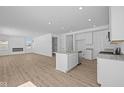 Modern kitchen with stainless steel appliances, white cabinetry, and an island at 6114 Paperbark Way, Indianapolis, IN 46259
