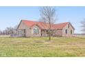 Brick ranch house with red roof, deck, and expansive yard at 6511 N 550 E, Lebanon, IN 46052