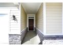 Welcoming entryway with stone accents and a dark wood front door at 68 Sterling Pl, New Whiteland, IN 46184