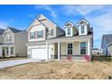 Charming two-story home with stone accents, large windows, and a two-car garage at 68 Sterling Pl, New Whiteland, IN 46184
