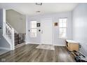 Welcoming foyer featuring wood-look floors and a staircase with a safety gate at 8908 Torrance Pl, Fishers, IN 46038