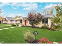 Cute yellow house with red door, well-manicured lawn, and American flag at 231 2Nd Ne St, Carmel, IN 46032