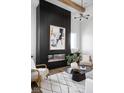 Modern living room showcasing a striking black slat wall fireplace with stylish decor and comfortable seating at 17368 Pinellas Ave, Westfield, IN 46074