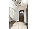 Elegant entryway with a circular rug and hardwood floors at 520 Bridgemont Ln, Carmel, IN 46032