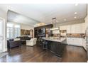 Open concept kitchen with island and stainless steel appliances at 520 Bridgemont Ln, Carmel, IN 46032