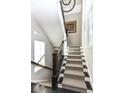 Grand staircase with herringbone patterned carpet runner at 520 Bridgemont Ln, Carmel, IN 46032