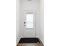 Welcoming entryway showcasing a clean, simple design with hardwood floors and a modern door at 7840 Magnolia St, New Palestine, IN 46163