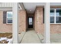 Elegant entryway showcasing a classic front door with sidelights and decorative hardware at 7840 Magnolia St, New Palestine, IN 46163