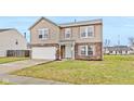 Two-story house with tan siding, brick accents, and a two-car garage at 8414 Ingalls Way, Camby, IN 46113
