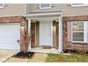 Front entrance with white door, brick columns, and landscaping at 8414 Ingalls Way, Camby, IN 46113