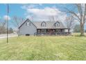Charming exterior with manicured lawn, covered porch, and patriotic decor at 11197 N Gasburg Rd, Mooresville, IN 46158