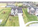 Two-story house with a driveway and a backyard, viewed from above at 11323 Long Sotton Ln, Fishers, IN 46037