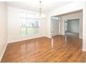 Bright dining room with hardwood floors and large windows at 11323 Long Sotton Ln, Fishers, IN 46037