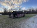 Small pink brick house with porch and gravel area at 412 S Main St, Brooklyn, IN 46151