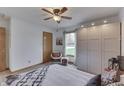Comfortable bedroom with a ceiling fan, wardrobe, and a view to the outside at 4208 E Epler Ave, Indianapolis, IN 46237