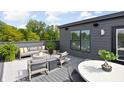 Modern rooftop deck features comfortable seating and a dining area, perfect for outdoor entertaining at 9895 Baneberry Ln, Carmel, IN 46290